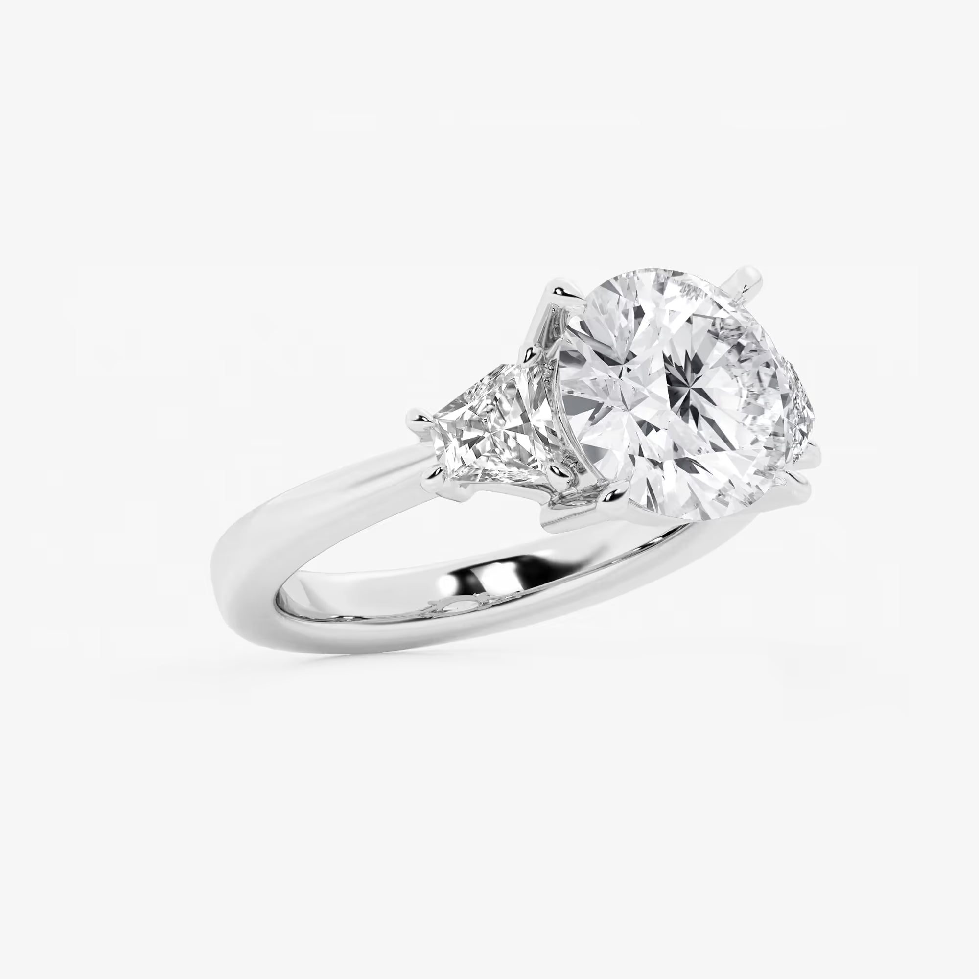 Three Stone Trillion Cut Engagement Ring in White Gold with Round Brilliant Center Stone